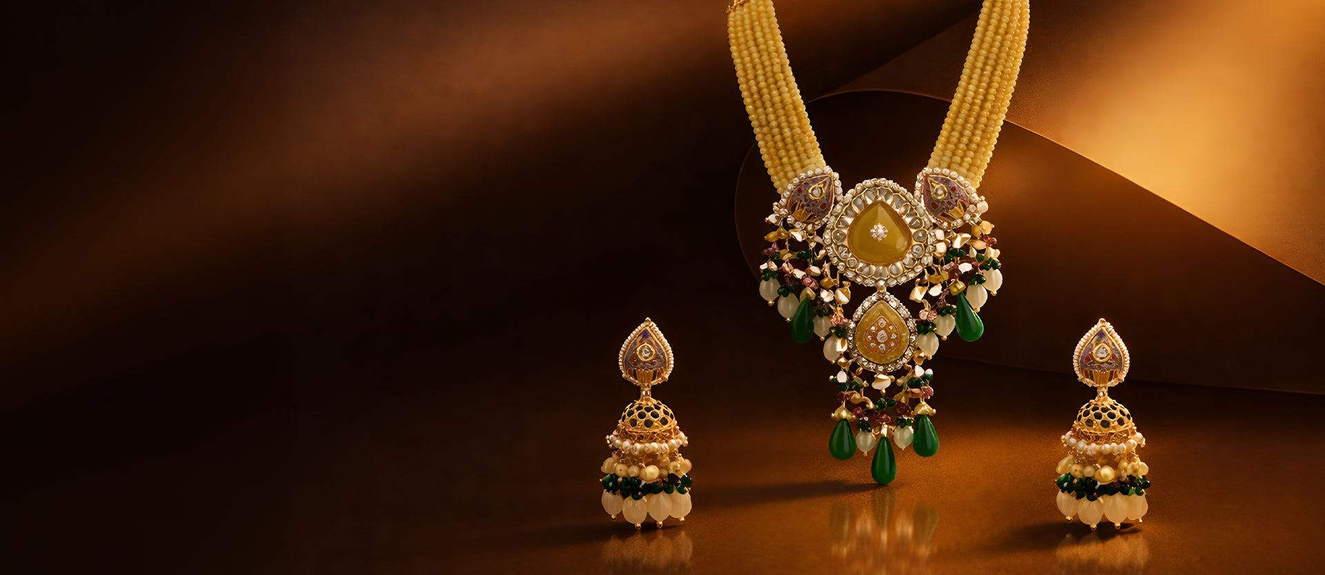 Ornate necklace with matching earrings on a reflective surface
